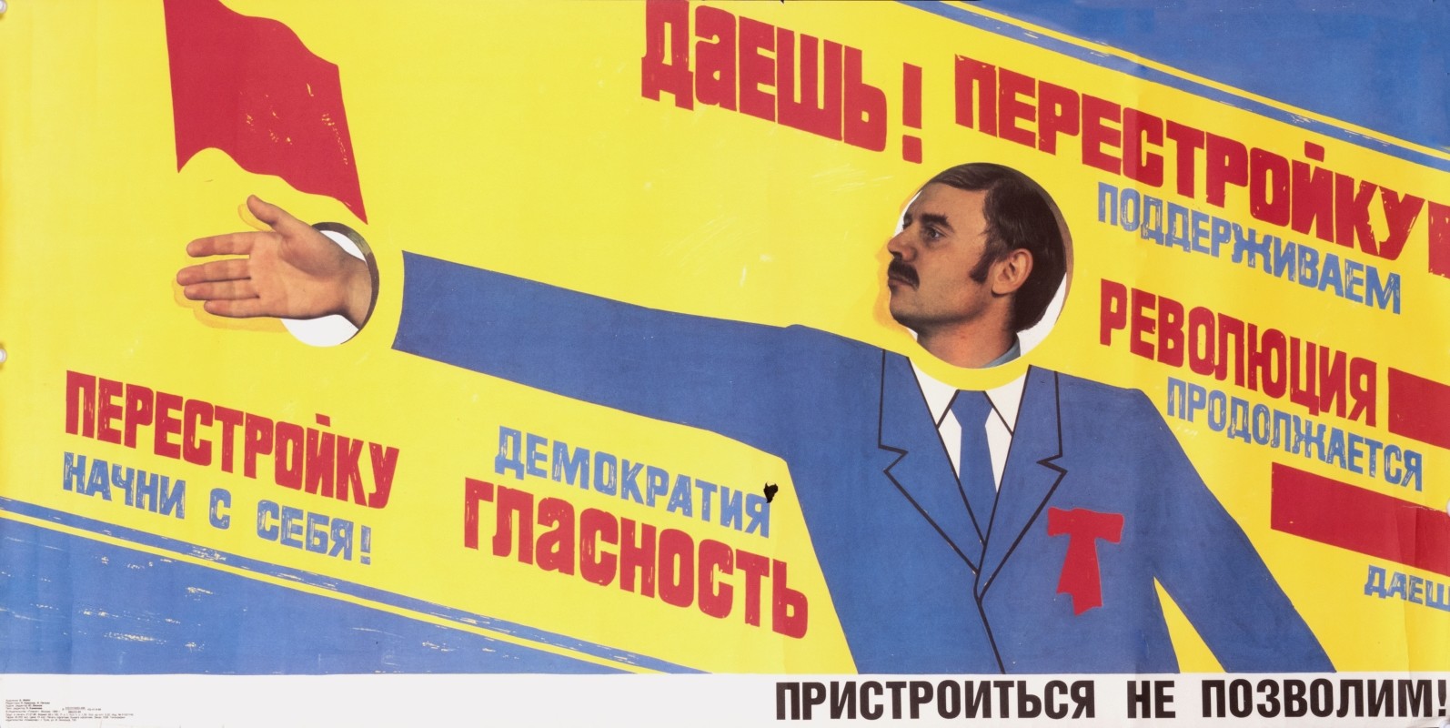 Man puts his face and hand in cut-out slogan; blue, red, yellow