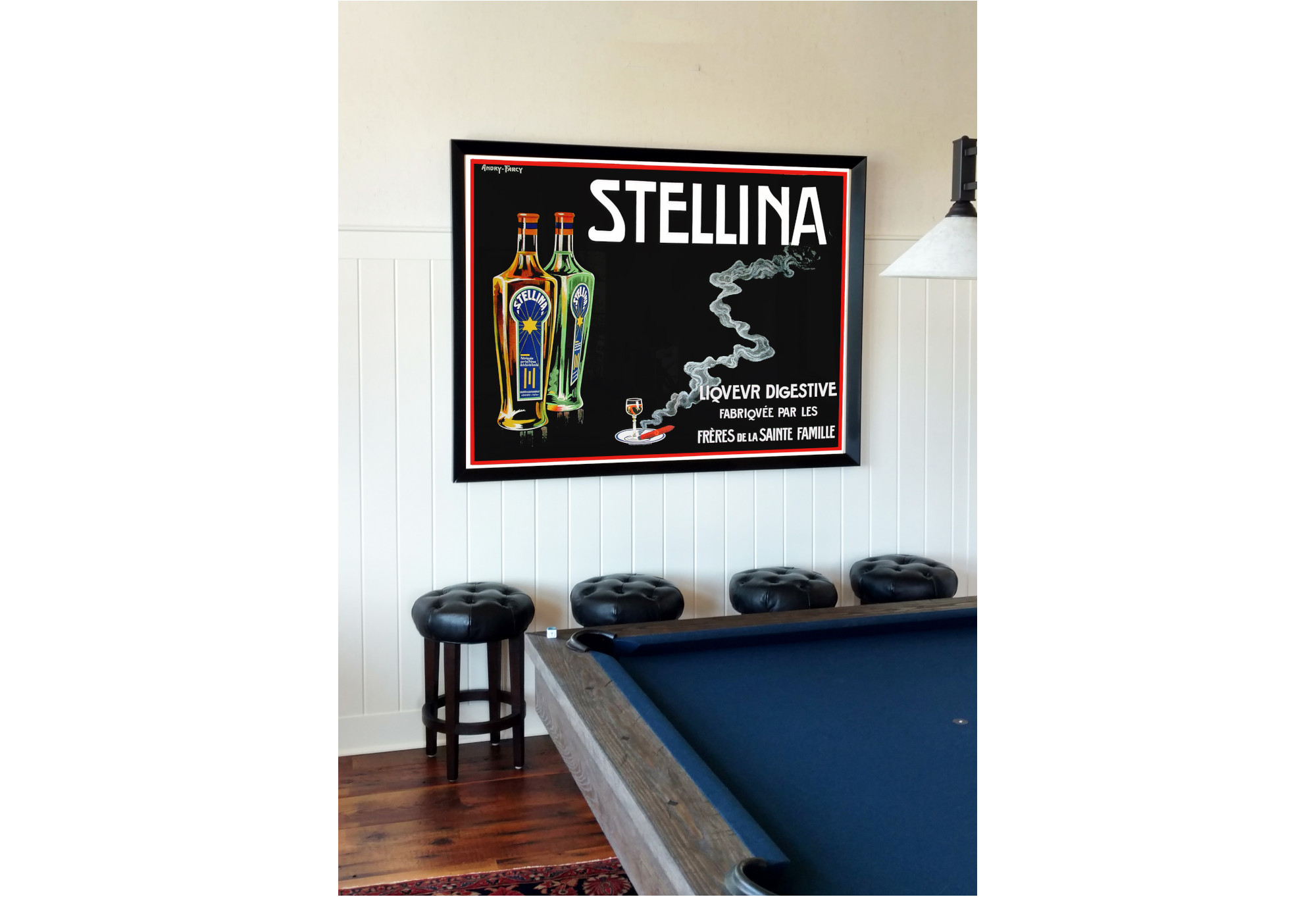 blue pool table with vintage liquor poster on wall; blue, white, green, red, yellow