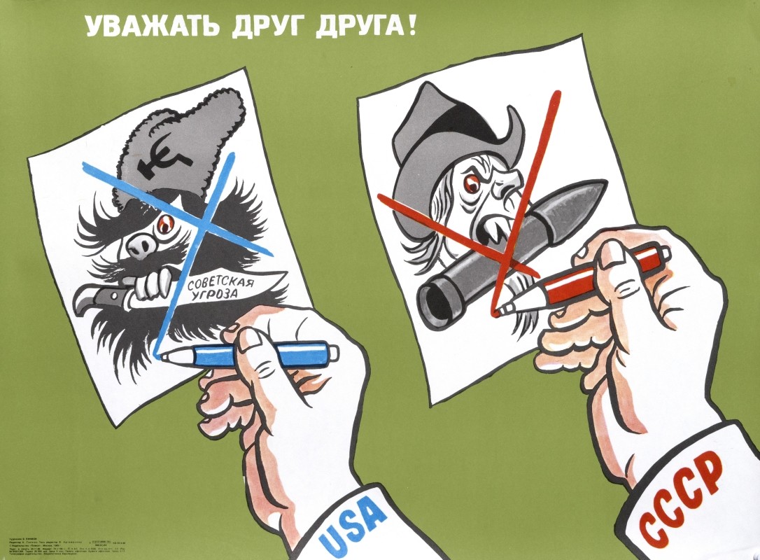 two hands holding up caricature portraits; green white, grey