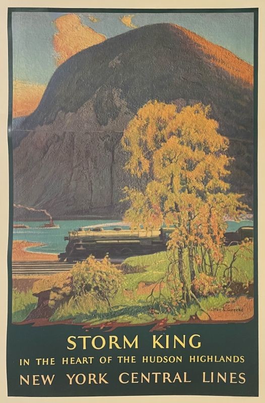 View of train in front of lake and mountain, with trees in foreground; blue, green, yellow, orange
